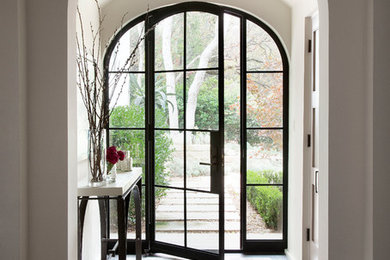 Inspiration for a transitional dark wood floor entryway remodel in Austin with a metal front door