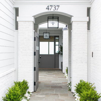Mid-sized cottage entryway photo in Orange County with white walls and a gray front door