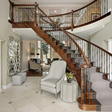 Suspended, Curved Wood Staircase with Iron Balusters