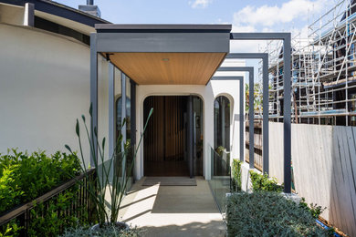 Contemporary front door in Auckland with a pivot front door and a black front door.