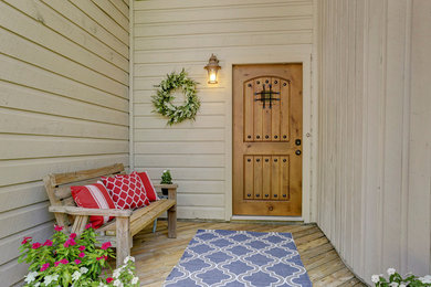 ヒューストンにある中くらいなトラディショナルスタイルのおしゃれな玄関ドア (木目調のドア、茶色い床) の写真