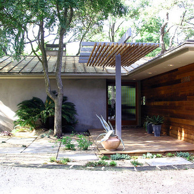 Example of a trendy entryway design in Austin with a glass front door