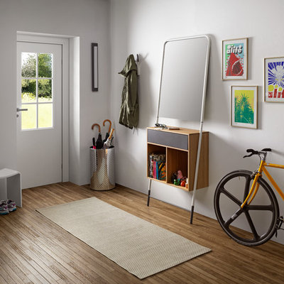 Example of a mid-sized danish light wood floor foyer design in Venice with white walls