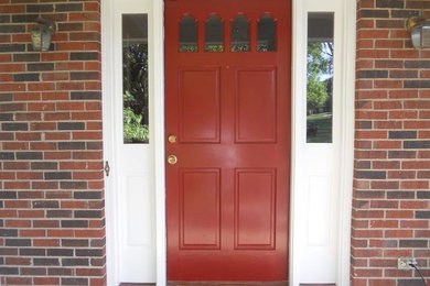 Inspiration for a cottage entryway remodel in Charlotte with a red front door
