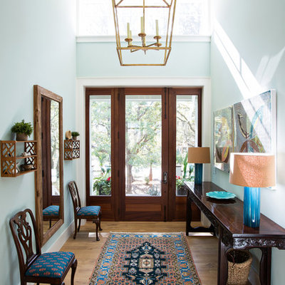 Entryway - mid-sized traditional medium tone wood floor and brown floor entryway idea in Charleston with blue walls and a glass front door