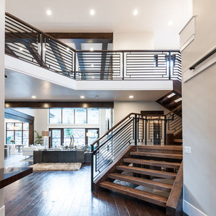 Entryway - mid-sized transitional dark wood floor entryway idea in Salt Lake City with gray walls and a dark wood front door