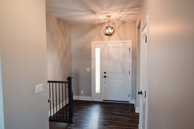 Example of a mid-sized classic light wood floor entryway design in Other