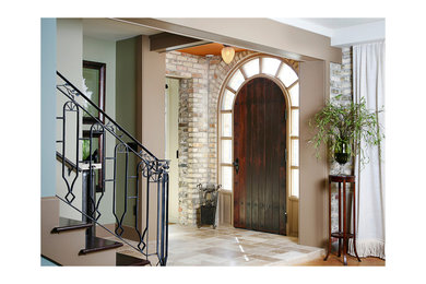 Photo of a large classic foyer in Grand Rapids with multi-coloured walls, limestone flooring, a single front door and a dark wood front door.