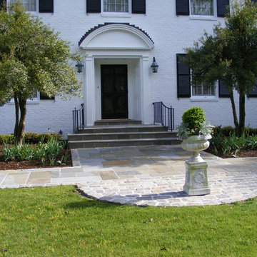 This Bluestone and cobblestone landing mimics curved shape of the entry detail
