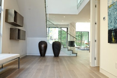 Entryway - modern medium tone wood floor entryway idea in Los Angeles