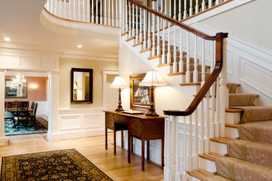Inspiration for a mid-sized timeless light wood floor and beige floor foyer remodel in Boston with beige walls
