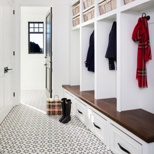 Immagine di un grande ingresso con anticamera chic con pareti bianche, una porta singola, pavimento con piastrelle in ceramica e pavimento multicolore