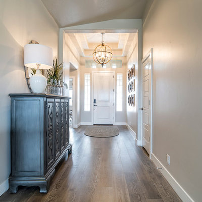 Mid-sized transitional medium tone wood floor entryway photo in Salt Lake City with a white front door and gray walls