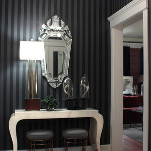 Inspiration for a transitional medium tone wood floor entryway remodel in Chicago with black walls