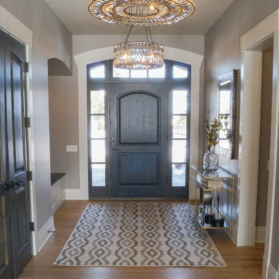 Mid-sized transitional light wood floor and brown floor entryway photo in Other with beige walls and a dark wood front door