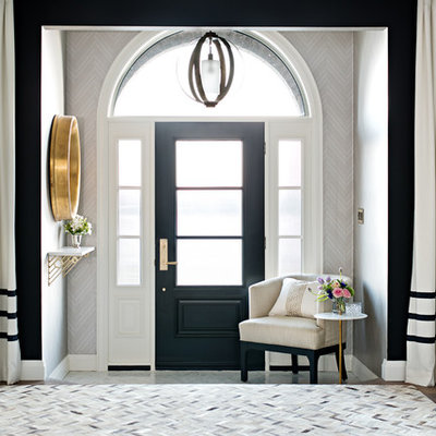 Example of a transitional dark wood floor entryway design in Toronto with gray walls and a black front door