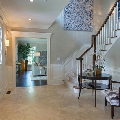 Mid-sized transitional travertine floor and beige floor entryway photo in New York with gray walls and a dark wood front door