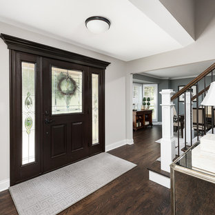 Inspiration for a large transitional dark wood floor and brown floor entryway remodel in Chicago with gray walls and a dark wood front door