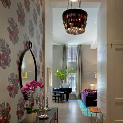 Trendy light wood floor entryway photo in New York with white walls