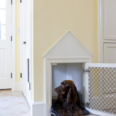 Elegant brick floor mudroom photo in Boston with yellow walls