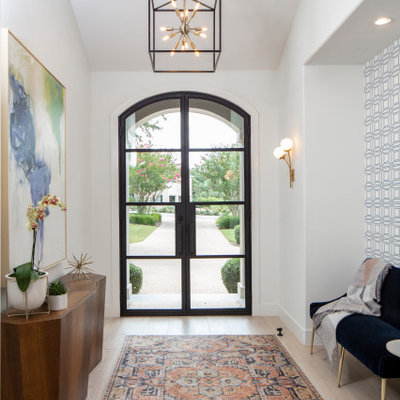 Entryway - mid-sized transitional light wood floor and beige floor entryway idea in Austin with white walls and a glass front door