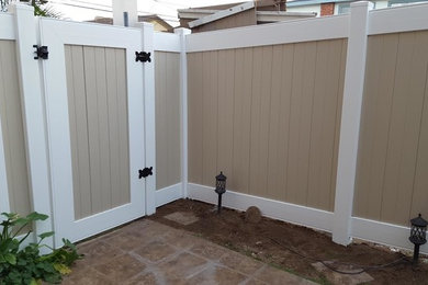 Inspiration for a transitional vinyl fence landscaping in Los Angeles.