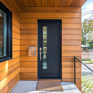 Ispirazione per una porta d'ingresso minimalista con una porta singola e una porta nera