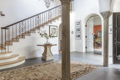 Entry hall - large mediterranean concrete floor and gray floor entry hall idea in San Francisco with white walls