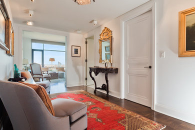 Mid-sized transitional medium tone wood floor entryway photo in New York with white walls and a white front door