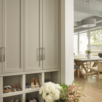 Example of a transitional gray floor mudroom design in Orlando with white walls