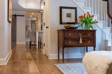 Entry hall - mid-sized traditional medium tone wood floor and brown floor entry hall idea in Other with white walls