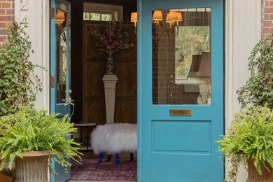 Example of an eclectic concrete floor double front door design in Raleigh with a blue front door