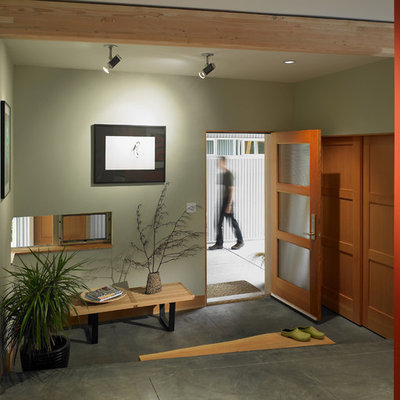 Trendy concrete floor and gray floor entryway photo in Seattle