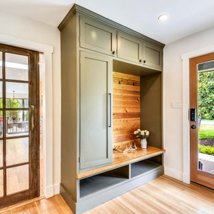 Ispirazione per un ingresso con anticamera contemporaneo con pareti bianche, parquet chiaro, una porta singola, una porta in vetro e pavimento beige