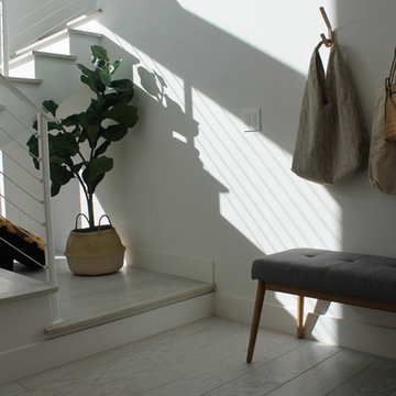 Wall Hooks, Bench and Fiddle Leaf Fig at Foot of Open Stairway