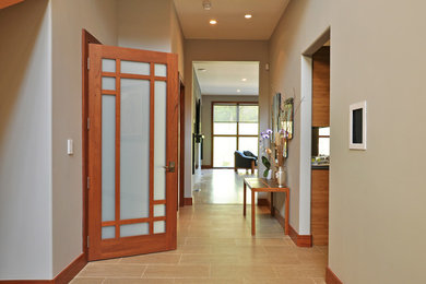 Mid-sized trendy porcelain tile and beige floor entryway photo in New York with beige walls and a medium wood front door