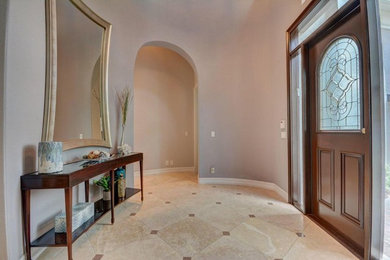 Large transitional marble floor and beige floor entryway photo in Miami with gray walls and a medium wood front door