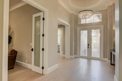 Large trendy porcelain tile and beige floor entryway photo in Miami with gray walls and a white front door