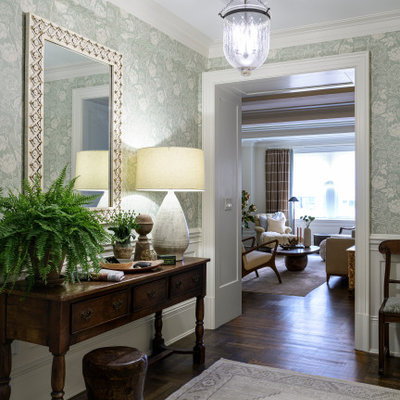 Example of a mid-sized transitional dark wood floor and brown floor entryway design in New York with white walls and a white front door