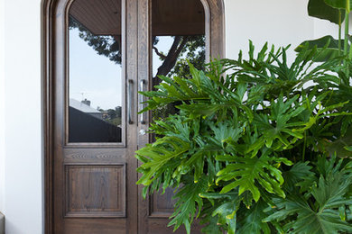 Idee per una grande porta d'ingresso contemporanea con pareti bianche, pavimento in gres porcellanato, una porta a due ante e una porta in legno bruno