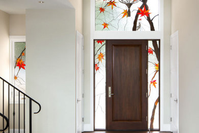 Inspiration for a medium tone wood floor and brown floor entryway remodel in Seattle with a dark wood front door