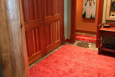 Example of a transitional entryway design in Vancouver with an orange front door