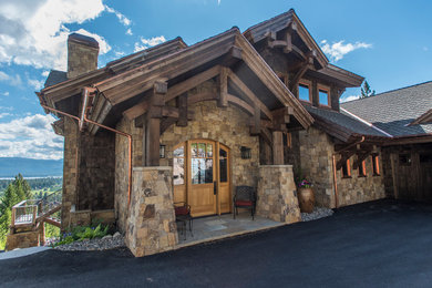 Large mountain style entryway photo in Boise with a light wood front door