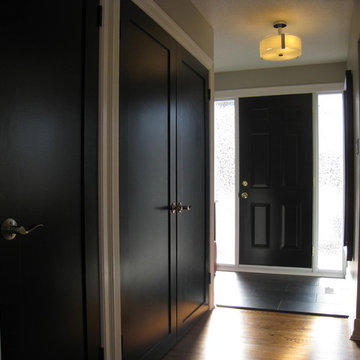 Wider view of hall with black doors