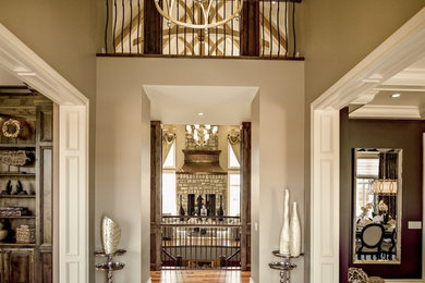 Example of a large mountain style medium tone wood floor foyer design in Calgary