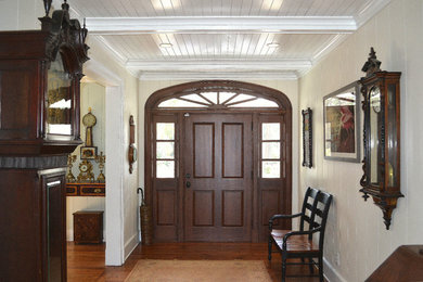 Mid-sized elegant medium tone wood floor and brown floor entryway photo in Atlanta with beige walls and a dark wood front door