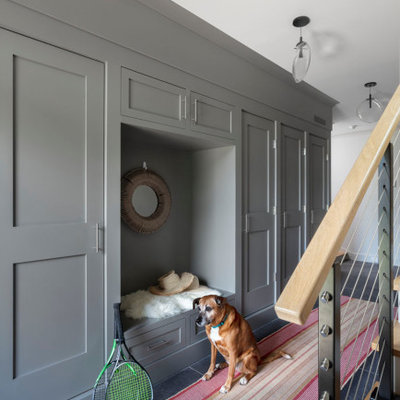 Inspiration for a large transitional gray floor and slate floor mudroom remodel in New York with white walls