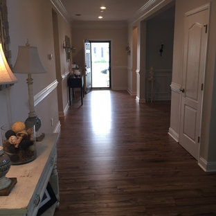 Foto de distribuidor clásico renovado, grande, con paredes beige, puerta simple, puerta negra y suelo laminado