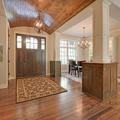 Entryway - traditional medium tone wood floor entryway idea in Minneapolis with beige walls and a medium wood front door