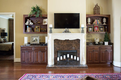 Example of a tuscan dark wood floor foyer design in Other with beige walls